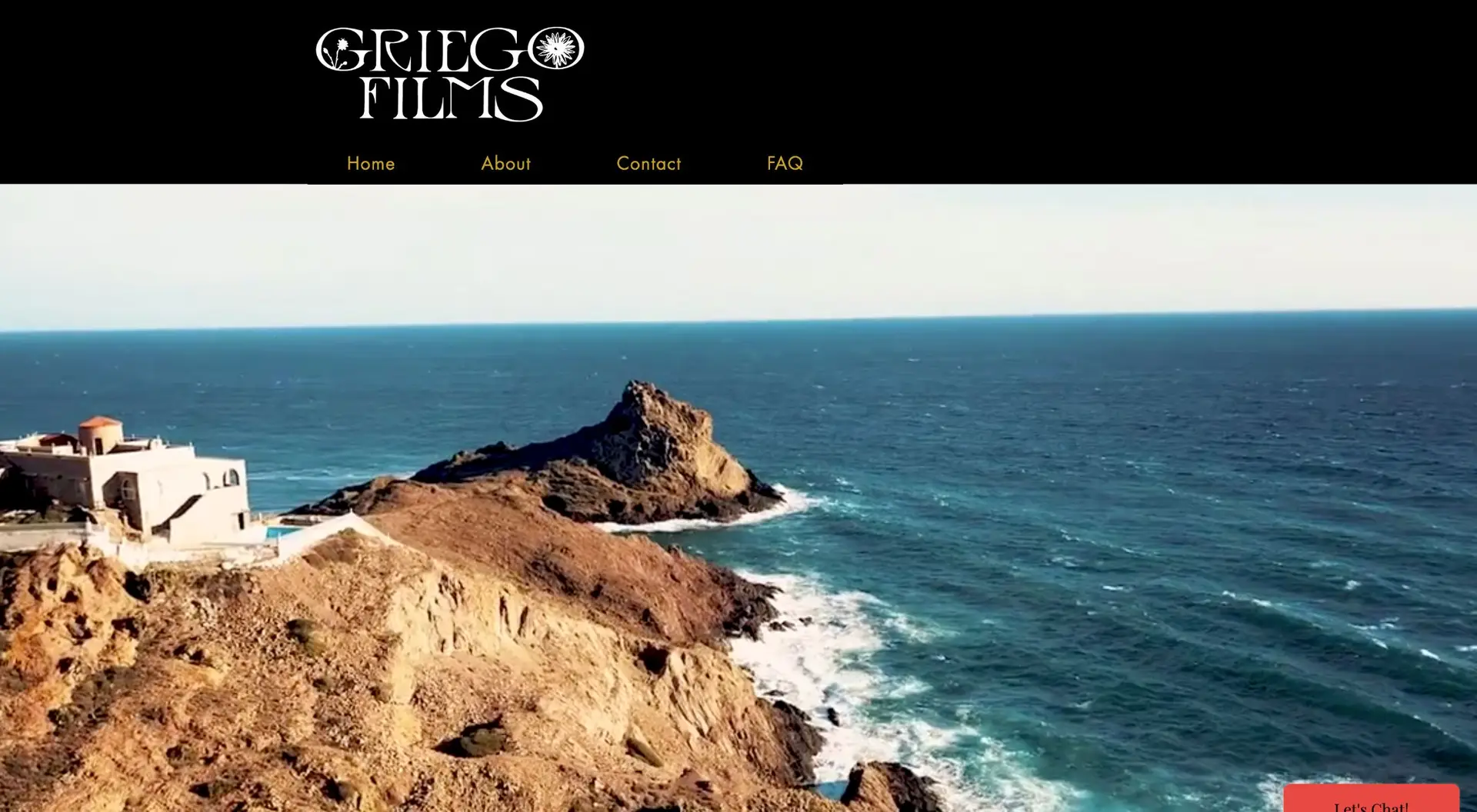 The image displays a coastal view with rugged cliffs and a rough sea. a house sits near the edge overlooking the sea, under a clear blue sky. "griego films" is written at the top with a website navigation bar.