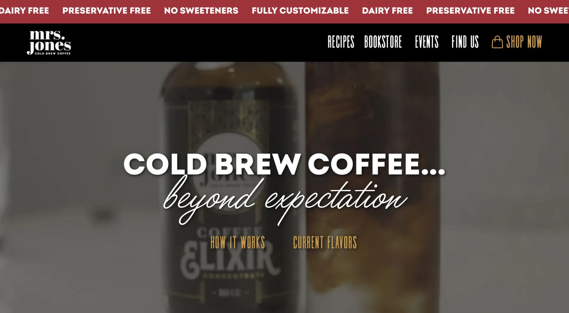 Website homepage promoting cold brew coffee, featuring a close-up of a coffee bottle labeled "mrs. jones" with the text "cold brew coffee... beyond expectation" overlaid. navigation links and tags are visible.